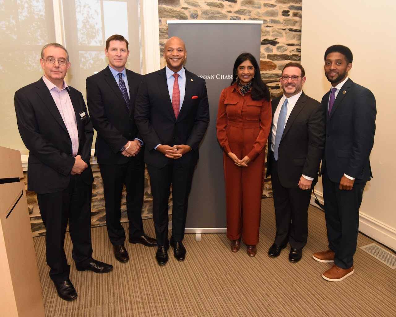 Governor Moore and Lieutenant Governor Miller stand with Mayor Brandon Scott and members of JPMorgan Chase.